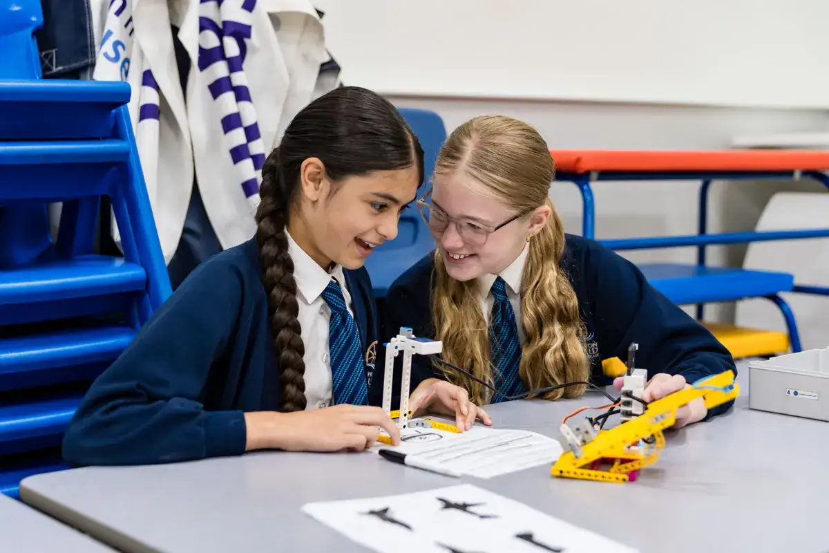 Students collaborating on a STEM robotics project during a Hyett Education workshop