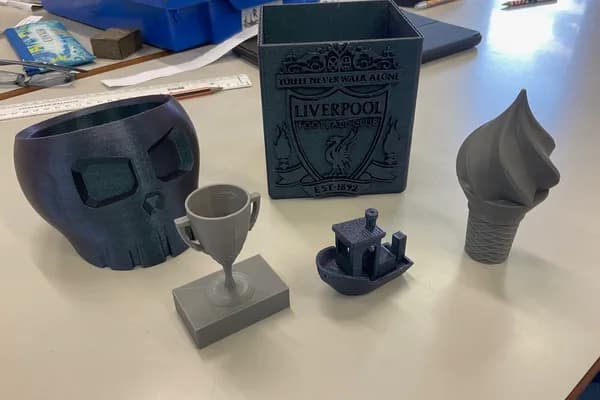 Students using 3D design software and 3D printers